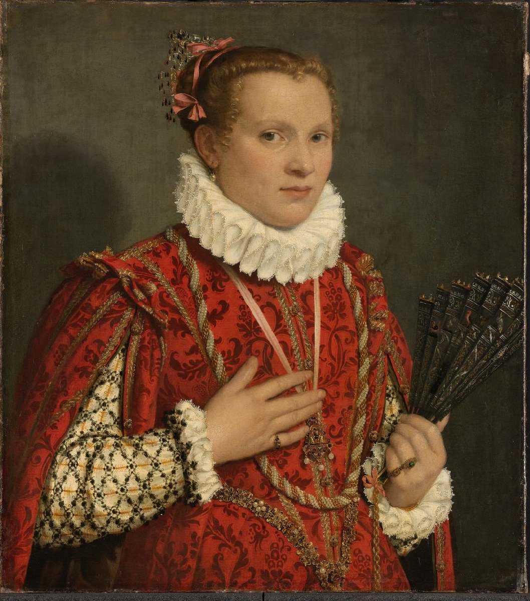 Portrait of a young woman holding a fan