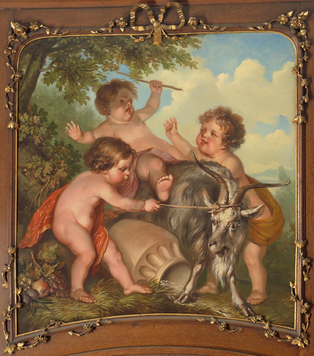 Drie kinderen spelend met een bok